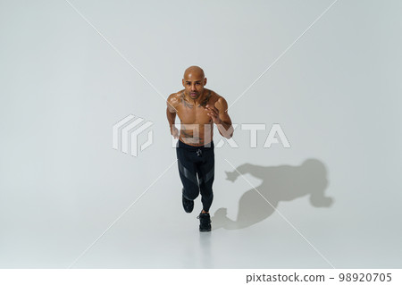 Top view of Professional male athlete running isolated on white studio background with shadows Top view of Professional male athlete running isolated on white studio background with shadows 98920705