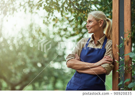 Smiling middle aged caucasian business woman in garden Smiling middle aged caucasian business woman in garden 98920835