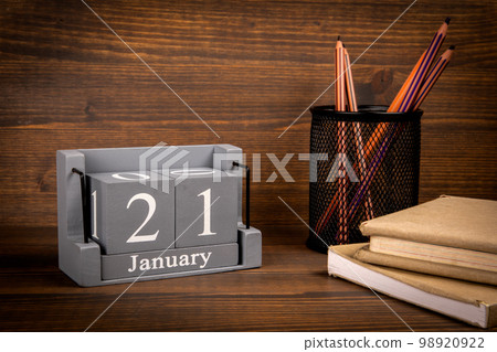 21 January inscription on wooden calendar. Wooden office desk 98920922