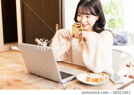 College student enjoying videos on laptop 98922841