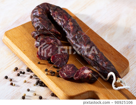 French tasty meal dry-cured sausage with liver at wooden desk 98925106
