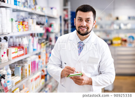 Portrait of male pharmacist working in drugstore Portrait of male pharmacist working in drugstore 98925338