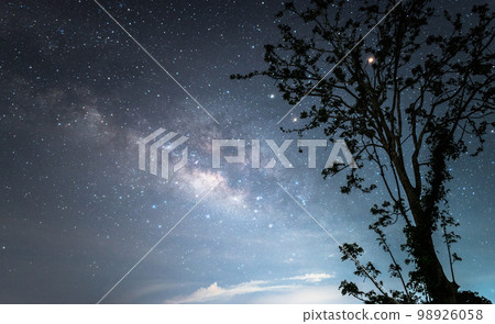 The Milky way galaxy over the starry night sky. 98926058