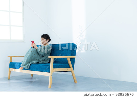 Elementary school girl looking at smartphone 98926676