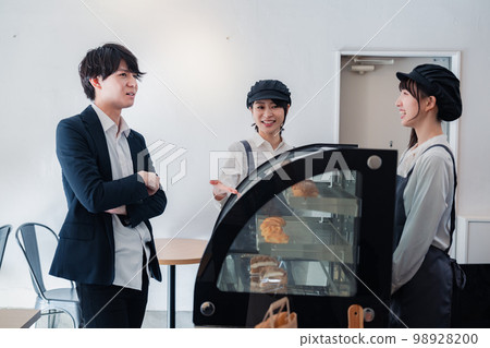 Businessman buying sweets at a pastry shop Businessman buying sweets at a pastry shop 98928200