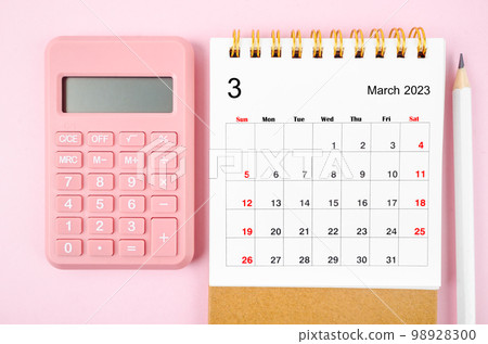 The March 2023 desk calendar for 2023 year with calculator on pink color background. The March 2023 desk calendar for 2023 year with calculator on pink color background. 98928300