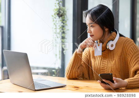 Asian woman holding credit card for online shopping and payment makes a purchase on the Internet, Online payment, Business financial and technology Asian woman holding credit card for online shopping and payment makes a purchase on the Internet, Online payment, Business financial and technology 98928898