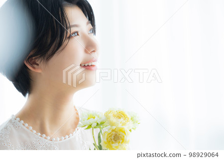 A woman with flowers 98929064