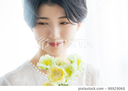 A woman with flowers 98929068