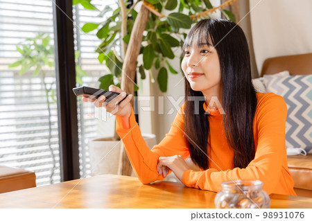 Young woman watching TV away from TV 98931076