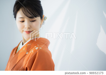 A woman in an orange visiting dress A woman in an orange visiting dress 98932173