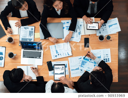 Business team of financial data analysis meeting report paper in harmony office. Business team of financial data analysis meeting report paper in harmony office. 98933969