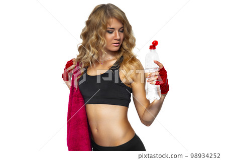 Portrait of girl with red towel who holding bottle of water on white background. Sports Hydration Portrait of girl with red towel who holding bottle of water on white background. Sports Hydration 98934252