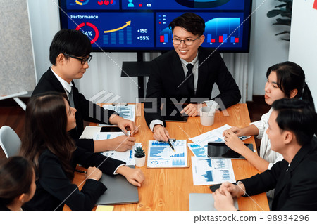 Business team of financial data analysis meeting report paper in harmony office. Business team of financial data analysis meeting report paper in harmony office. 98934296