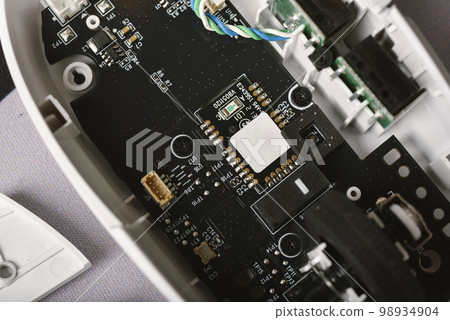 Separated parts of broken mouse, Disassembled computer mouse for repair and fixing. 98934904