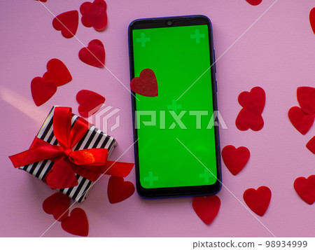 Flat lay with a lot of tiny heart-shaped papers with space for text 98934999