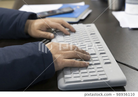person working with computer 98936110