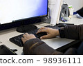 person working with computer 98936111