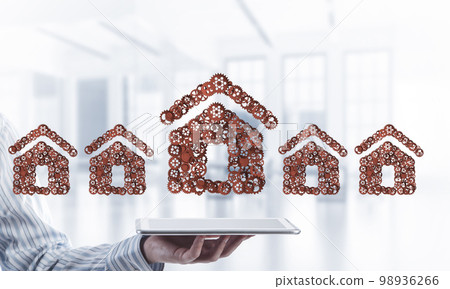 Real estate or construction idea presented by home icon on tablet pc 98936266