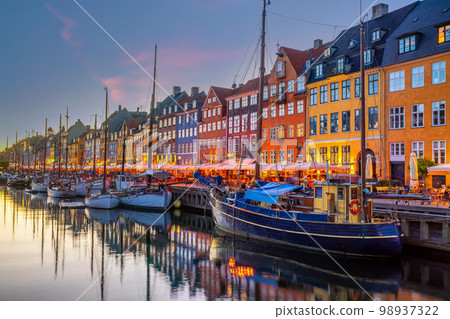 Copenhagen city skyline in Denmark at famous old Nyhavn port Copenhagen city skyline in Denmark at famous old Nyhavn port 98937322