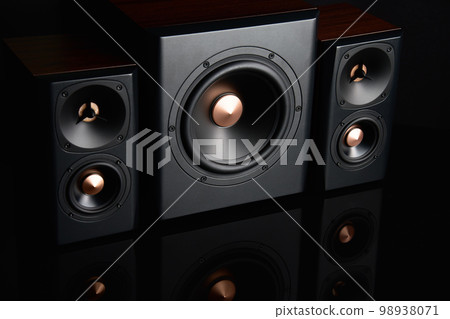 Two sound speakers and subwoofer on dark background. Set for listening music. Audio equipment 98938071