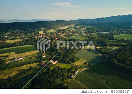 Overhead view of beautiful suburb landscape, Aerial view of countryside area with village and green fields near mountains 98938397