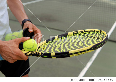 close-up. male hands holding tennis racket and balls close-up. male hands holding tennis racket and balls 98938539