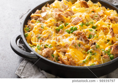 Creamy Tuna Casserole with green Peas and Egg Noodles closeup on the pan. Horizontal Creamy Tuna Casserole with green Peas and Egg Noodles closeup on the pan. Horizontal 98939797
