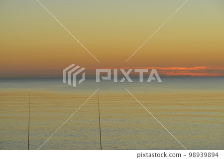 Autumn sunset sky and sea Two fishing rods on the left No people Photograph material [Photographed in: Hokkaido] 98939894