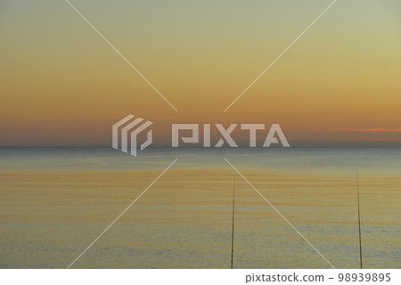 Autumn evening sky and sea Two fishing rods on the right screen No people Photo material [Photographed in Hokkaido] 98939895