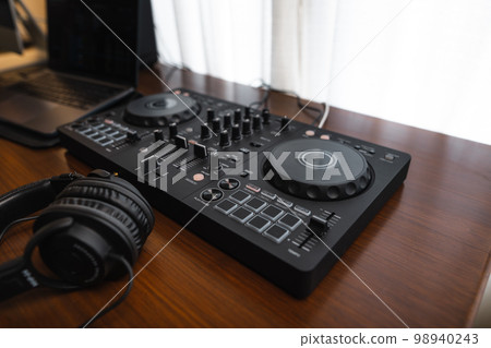 Close-up dj controller and Sound mixing desk at home Close-up dj controller and Sound mixing desk at home 98940243