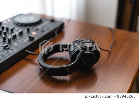 Close-up dj controller and Sound mixing desk at home Close-up dj controller and Sound mixing desk at home 98940265