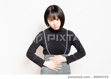 young woman holding her stomach 98940359