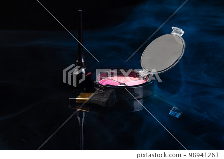 Close up make up cosmetic powder with brush. Black background with vapor. 98941261