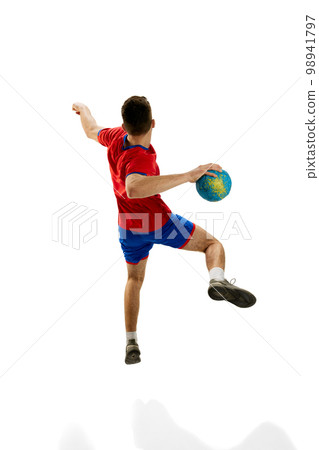 Back view. Dynamic studio shot of professional male handball player in motion training, playing isolated over white studio background. Concept of sport and competition Back view. Dynamic studio shot of professional male handball player in motion training, playing isolated over white studio background. Concept of sport and competition 98941797