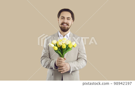Smiling man greet present flowers bouquet 98942197