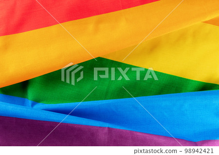 Gay pride flag. LGBTQ rainbow textile texture, overhead flat lay shot Gay pride flag. LGBTQ rainbow textile texture, overhead flat lay shot 98942421