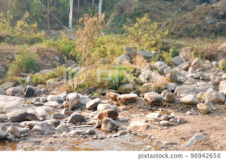 Large Igneous River Boulders and rocks has been carried by the river on the remote mountain place. Rangbang river mountain valley.Tabakoshi West Bengal India Large Igneous River Boulders and rocks has been carried by the river on the remote mountain place. Rangbang river mountain valley.Tabakoshi West Bengal India 98942658