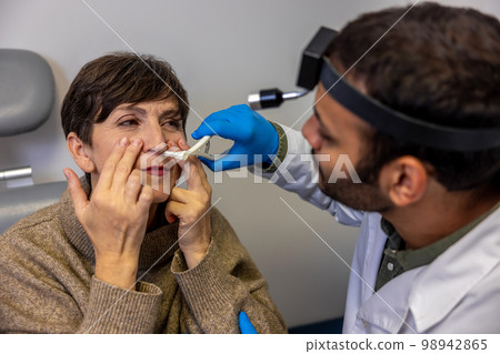 Senior woman having nasal checkup at ent doctor 98942865