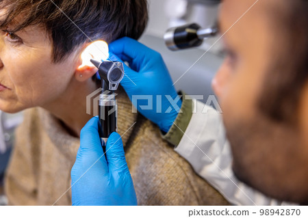 Senior woman having hearing checkup at ent doctor Senior woman having hearing checkup at ent doctor 98942870
