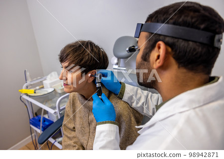 Senior woman having hearing checkup at ent doctor 98942871