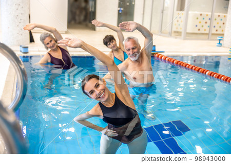 Group of seniors having aqua aerobics class Group of seniors having aqua aerobics class 98943000