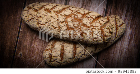 Rye bread on brown background Rye bread on brown background 98943882