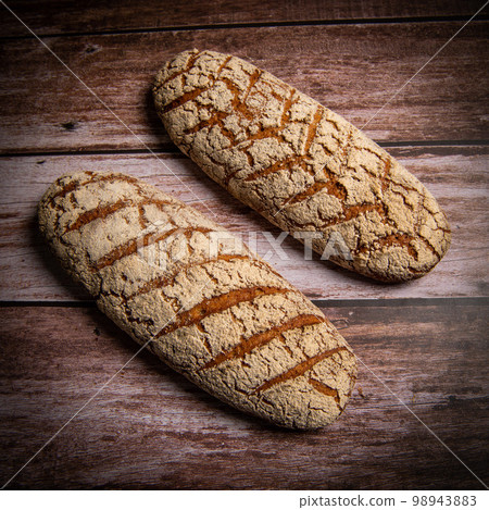 Rye bread on brown background 98943883