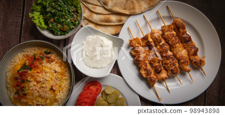 Lebanese recipe of chich taouk, garlic cream, toum, in a Lebanese bread, tabbouleh and chickpea Lebanese recipe of chich taouk, garlic cream, toum, in a Lebanese bread, tabbouleh and chickpea 98943898