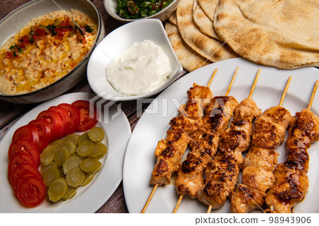 Lebanese recipe of chich taouk, garlic cream, toum, in a Lebanese bread, tabbouleh and chickpea 98943906