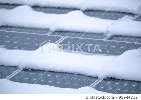 snow covered solar panel 98944212