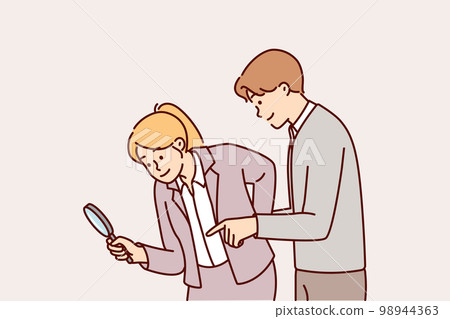 Man and woman working as detectives use magnifying glass during investigation to find evidence Man and woman working as detectives use magnifying glass during investigation to find evidence 98944363