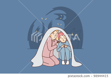 Teenage boy and girl sit wrapped in blanket scared of ghosts after watching scary movie Teenage boy and girl sit wrapped in blanket scared of ghosts after watching scary movie 98944415