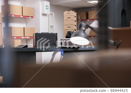 Empty interior of new large and modern storehouse space full with tall shelves completely filled with carton boxes and containers. Warehouse is a commercial building for storage of goods. Empty interior of new large and modern storehouse space full with tall shelves completely filled with carton boxes and containers. Warehouse is a commercial building for storage of goods. 98944425